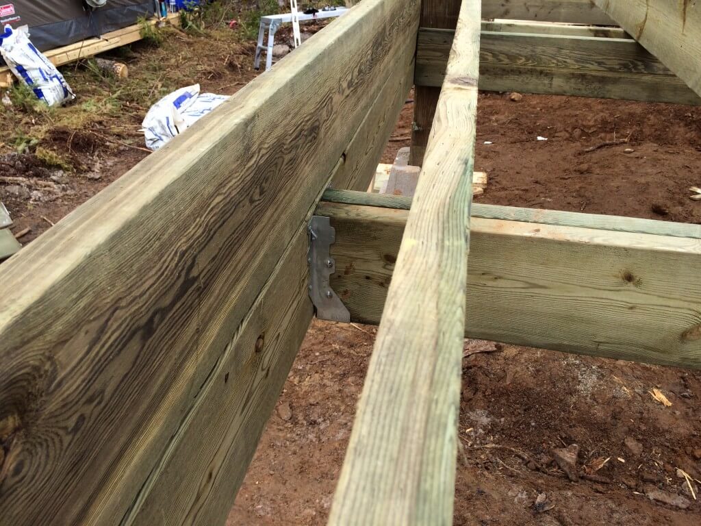 Cabin front deck subfloor framing with joist hangars