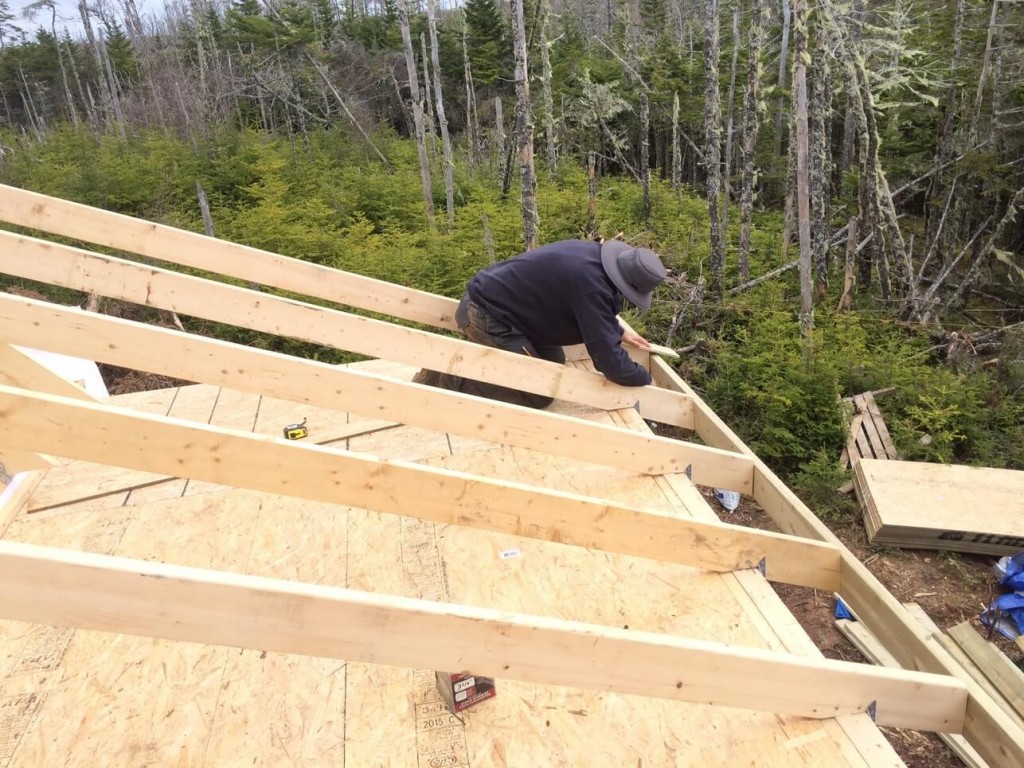 Aligning-Fascia-on-The-Off-Grid-Cabin-roof