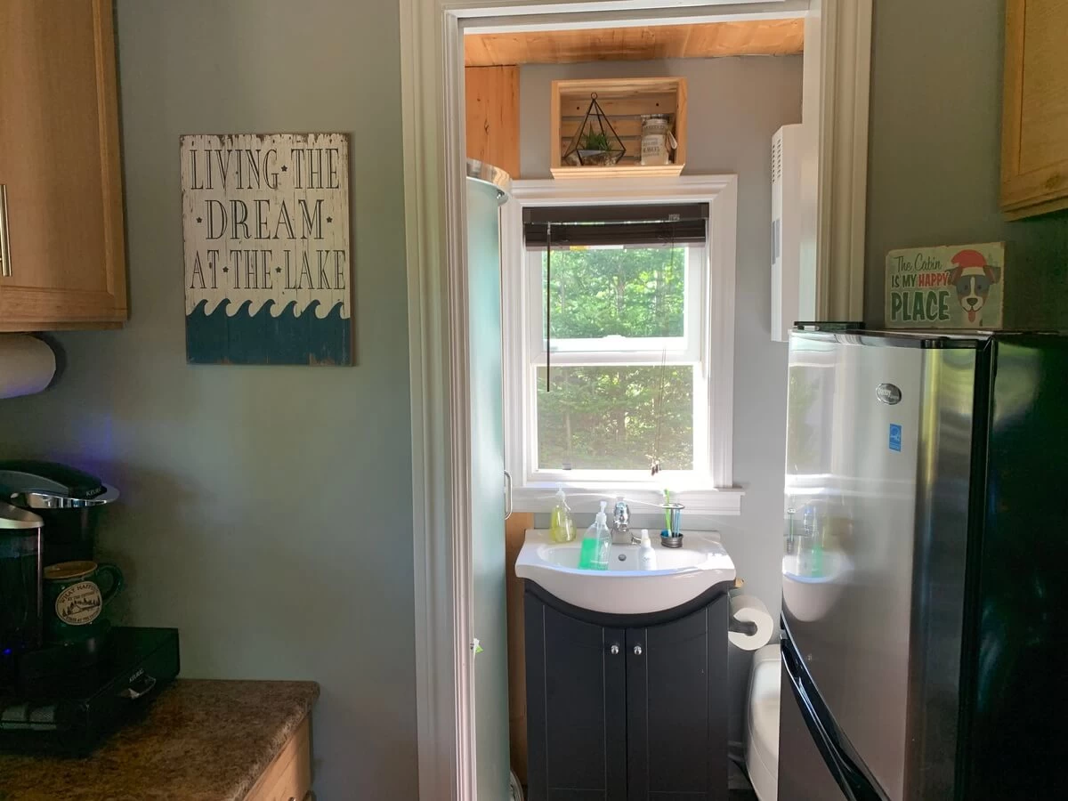 Bathroom vanity and sink viewed through the doorway from the cabin kitchen