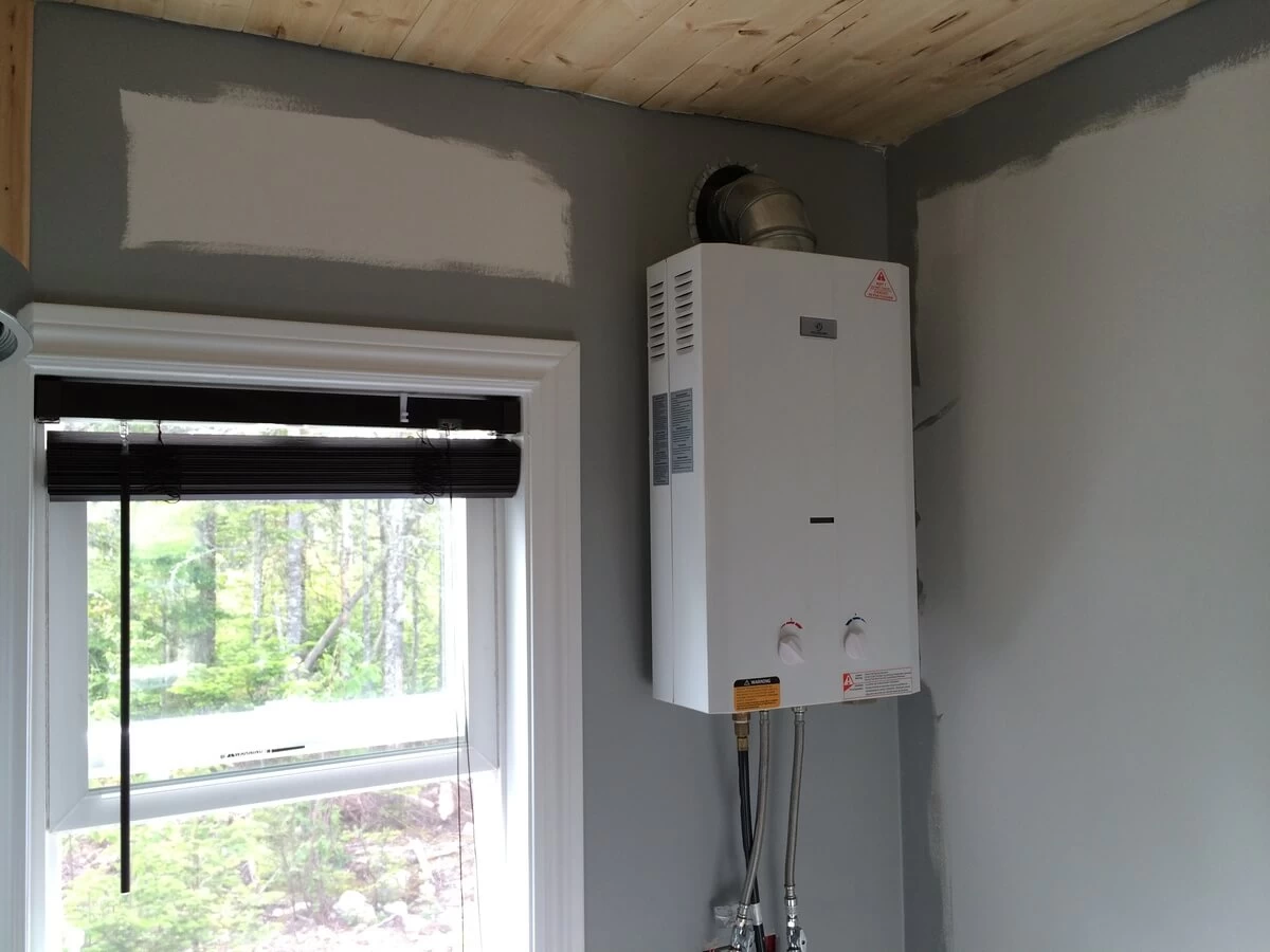 Eccotemp L10 water heater mounted beside the bathroom window